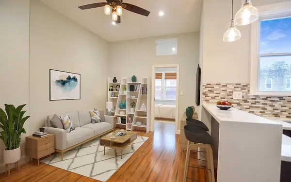 a living room with furniture and a chandelier