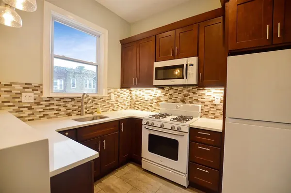 a kitchen with granite countertop cabinets stainless steel appliances and a sink