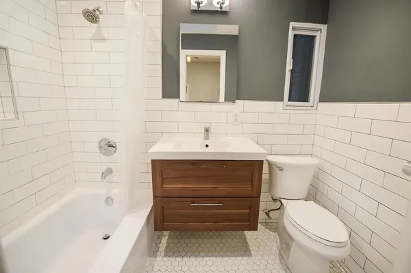 a bathroom with a toilet a sink and bathtub