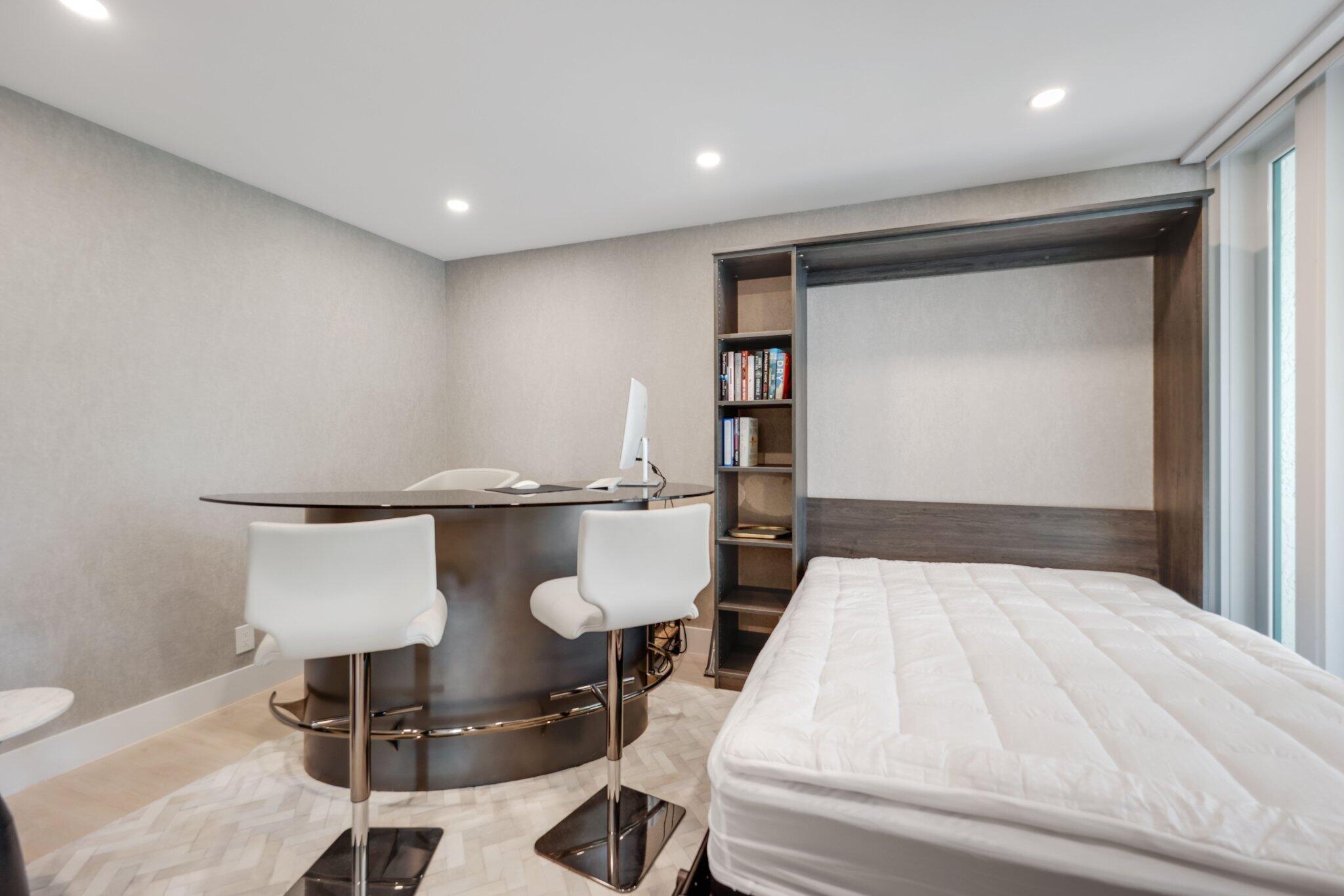 100 Southeast 5th Avenue, Unit 106 Boca Raton, FL 33432 - Photo 33 of 81 a bedroom with a bed and a table in it