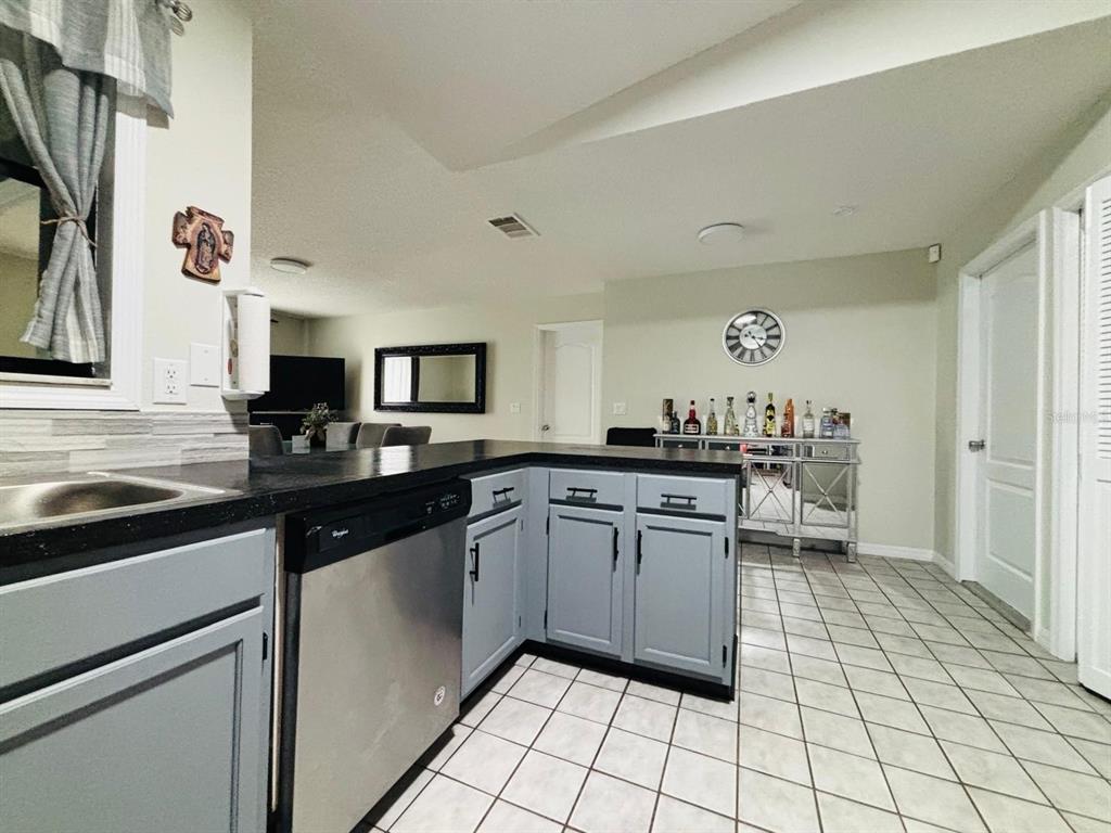 1464 Howland Boulevard Deltona, FL 32738 - Photo 11 of 55 a kitchen with a sink and cabinets