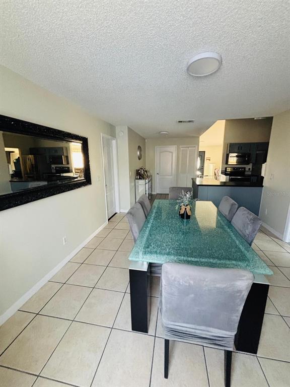 1464 Howland Boulevard Deltona, FL 32738 - Photo 13 of 55 a kitchen with kitchen island a counter top space a sink and appliances