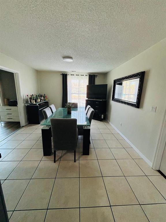1464 Howland Boulevard Deltona, FL 32738 - Photo 14 of 55 a living room with furniture and a flat screen tv
