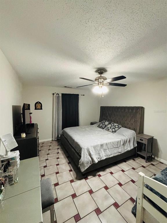 1464 Howland Boulevard Deltona, FL 32738 - Photo 16 of 55 a bedroom with a bed and wooden floor