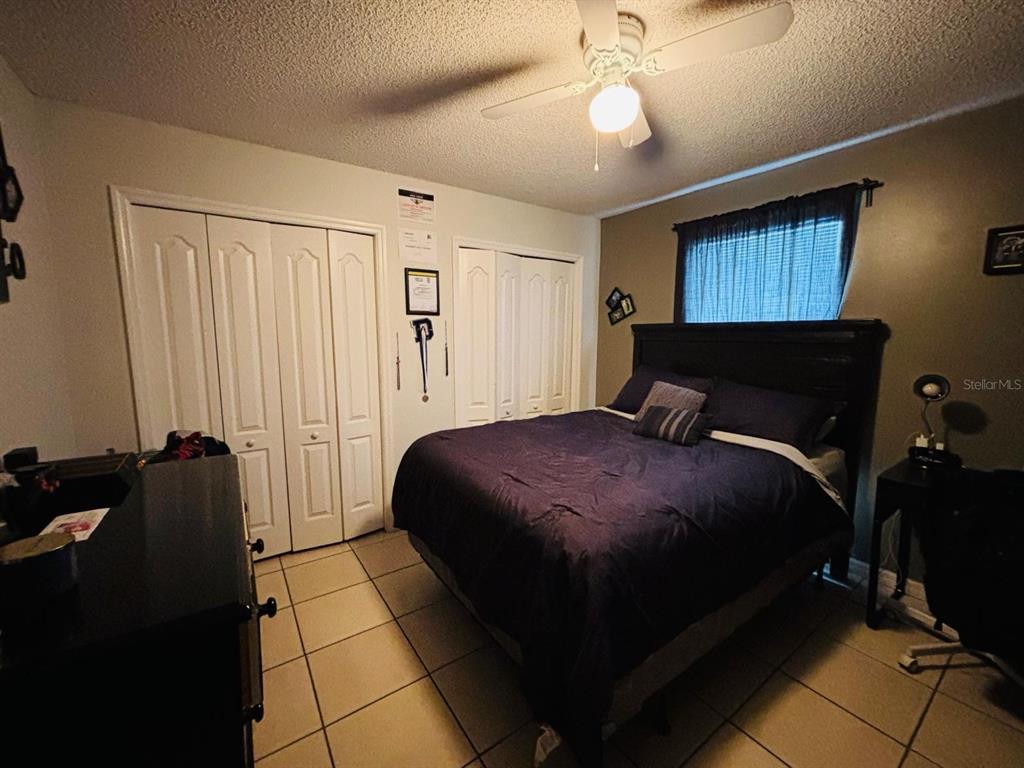 1464 Howland Boulevard Deltona, FL 32738 - Photo 19 of 55 a bedroom with a bed and wooden floor