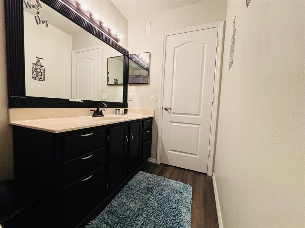 1464 Howland Boulevard Deltona, FL 32738 - Photo 20 of 55 a bathroom with a sink and a mirror