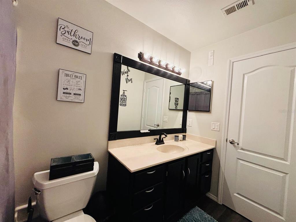 1464 Howland Boulevard Deltona, FL 32738 - Photo 22 of 55 a bathroom with a sink and a mirror