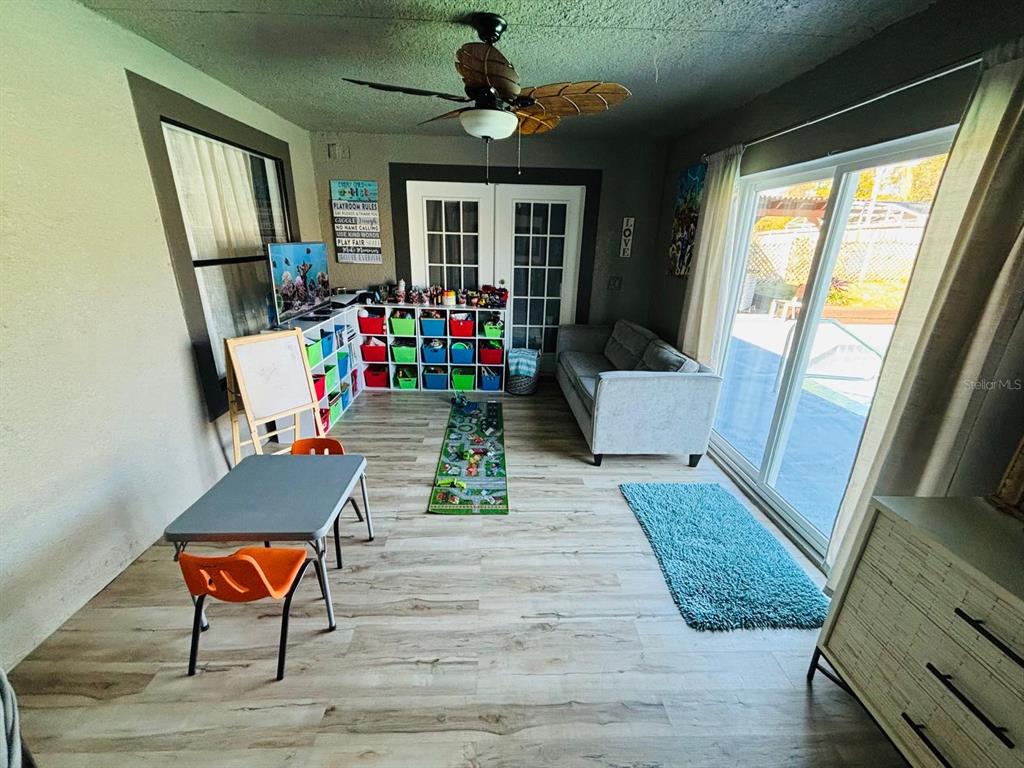 1464 Howland Boulevard Deltona, FL 32738 - Photo 27 of 55 a living room with furniture and a flat screen tv
