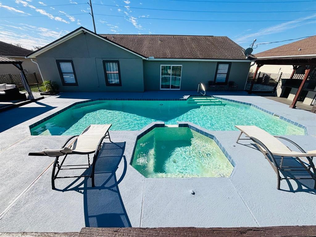 1464 Howland Boulevard Deltona, FL 32738 - Photo 34 of 55 a house view with a seating space and garden