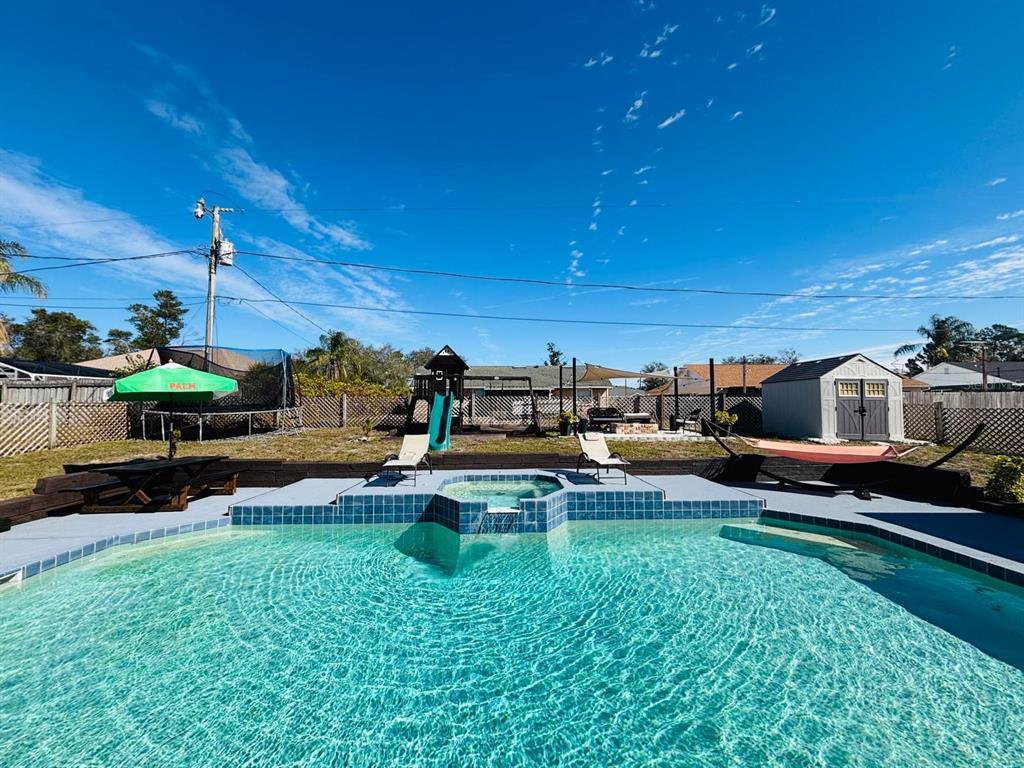 1464 Howland Boulevard Deltona, FL 32738 - Photo 35 of 55 a swimming pool with outdoor seating and yard