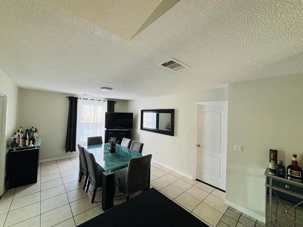 1464 Howland Boulevard Deltona, FL 32738 - Photo 47 of 55 a living room with furniture and a flat screen tv