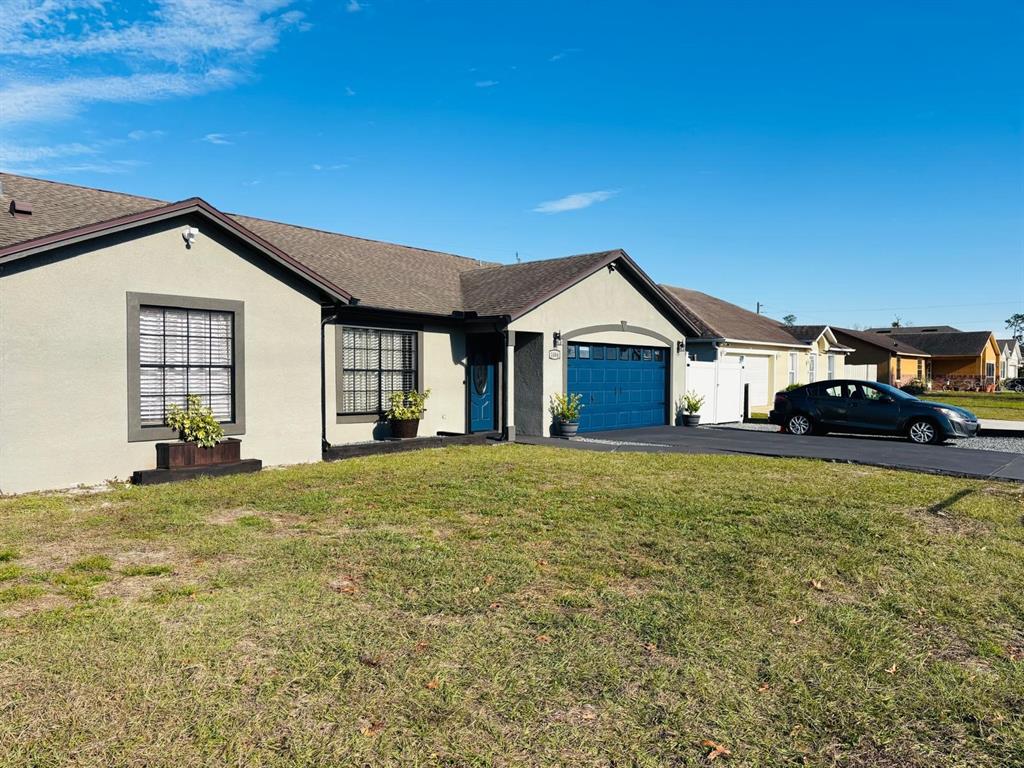 1464 Howland Boulevard Deltona, FL 32738 - Photo 54 of 55 a front view of a house with a garden