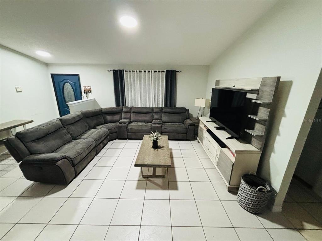 1464 Howland Boulevard Deltona, FL 32738 - Photo 7 of 55 a living room with furniture and a flat screen tv