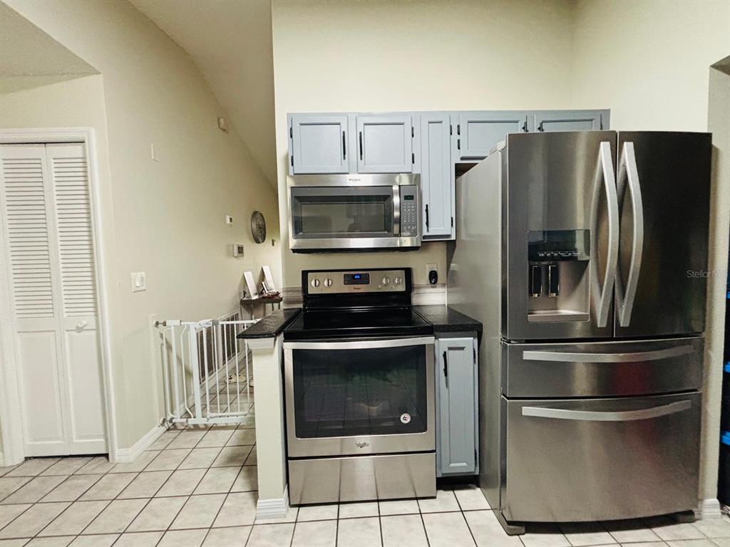 1464 Howland Boulevard Deltona, FL 32738 - Photo 8 of 55 a metallic refrigerator and stove sitting inside of a kitchen