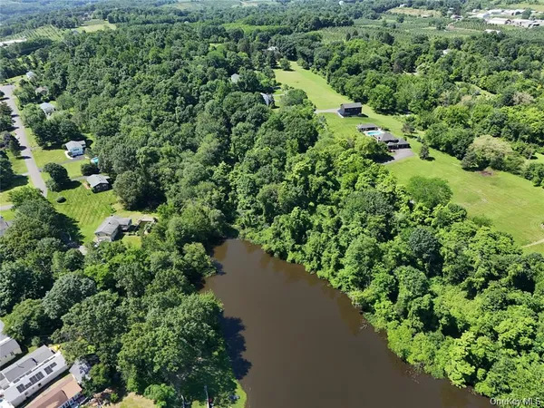 an aerial view of a house with a yard and lake view