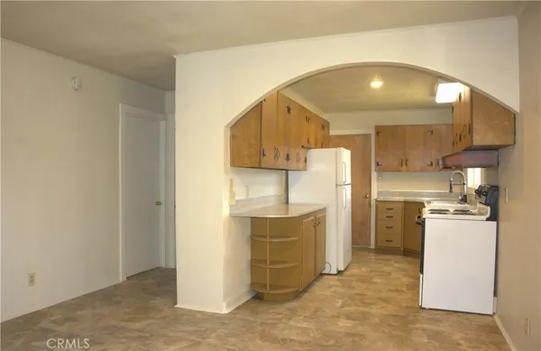 a kitchen with a refrigerator and a sink