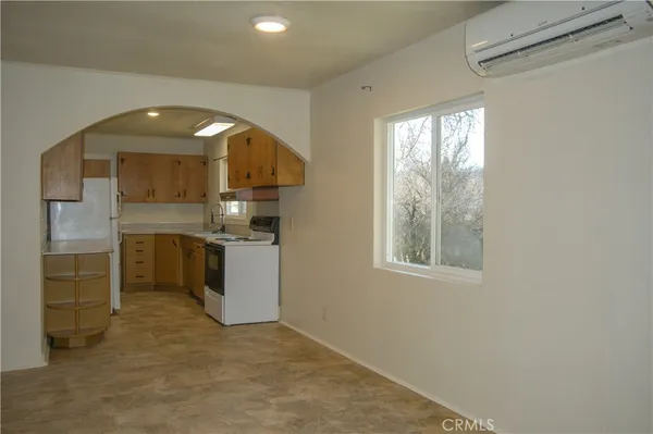 a view of a hallway with a kitchen