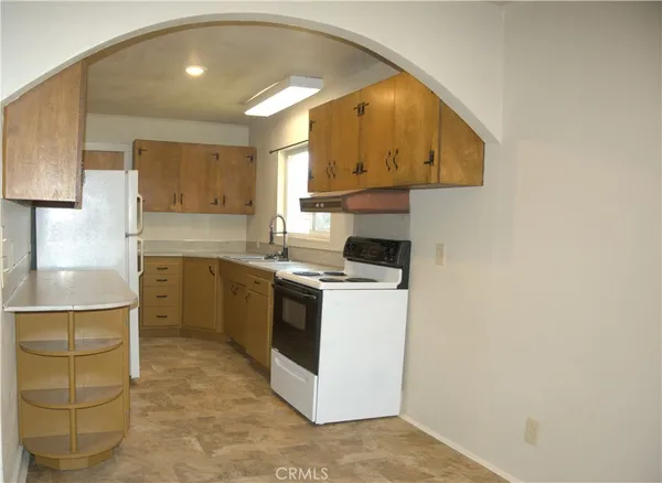 a kitchen with a sink cabinets and a window