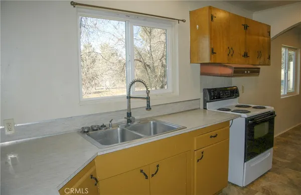 a kitchen with a sink cabinets and window