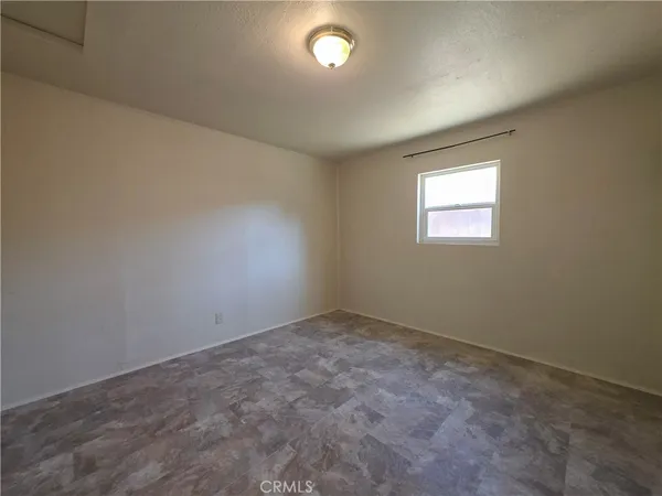 a view of an empty room and a hallway