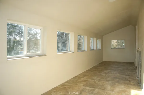 a view of a hallway with a wooden cabinets