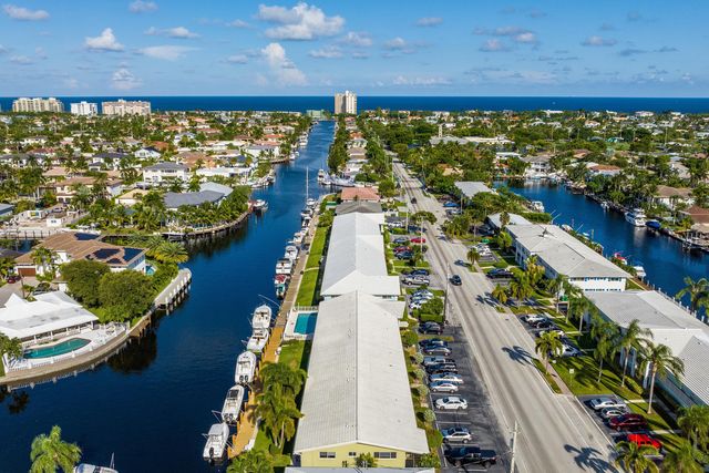a view of a hallway with a dining room and a window