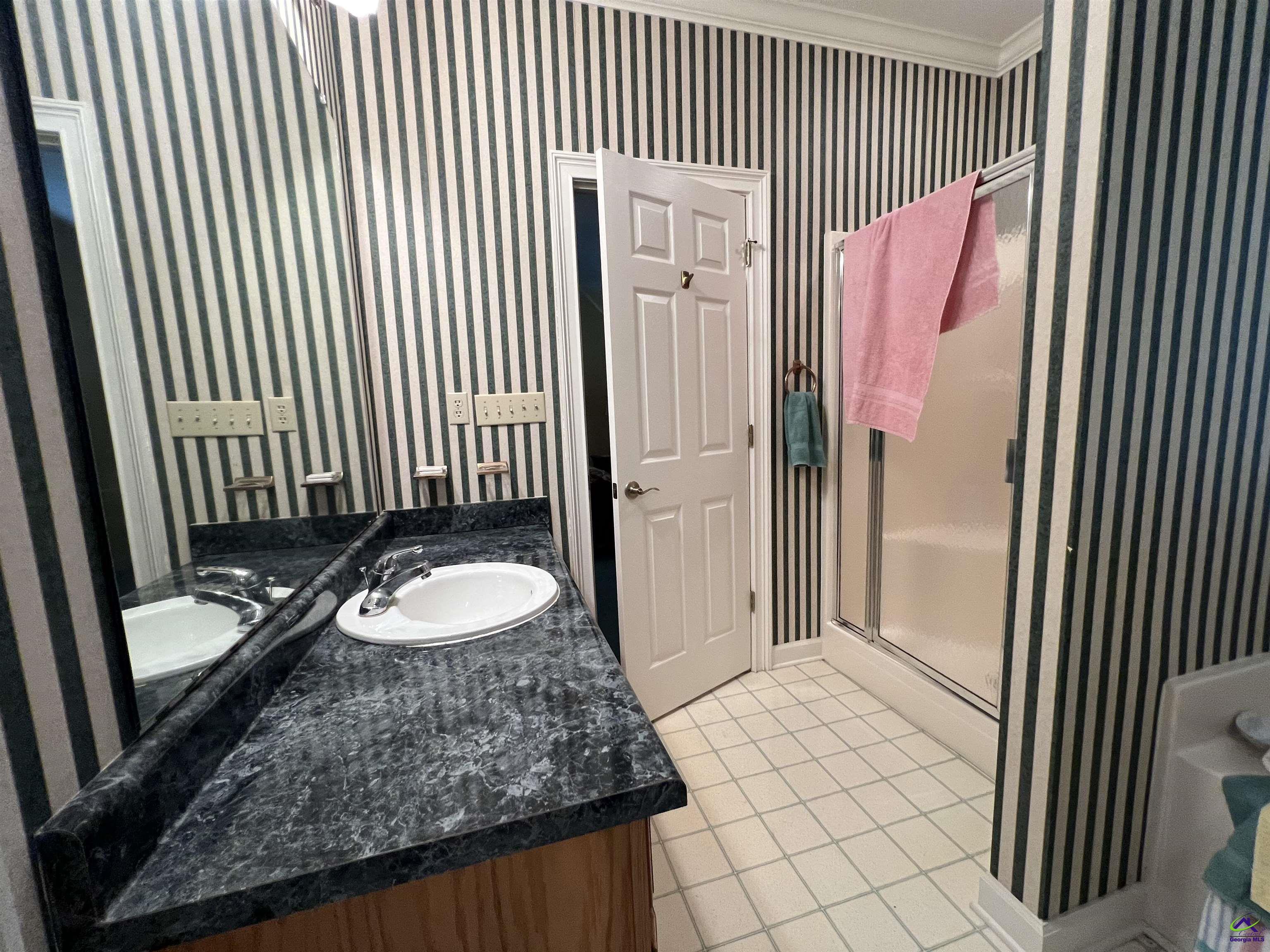 762 Nicholson-Carr Road Chester, GA 31012 - Photo 28 of 81 a bathroom with a granite countertop sink and a mirror