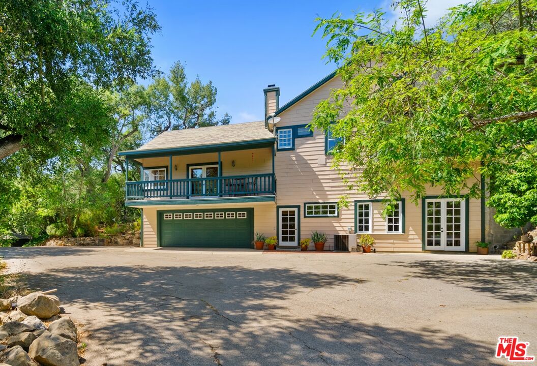 20912 Fontaine Road Topanga, CA 90290 - Photo 1 of 52 a front view of a house with a garden