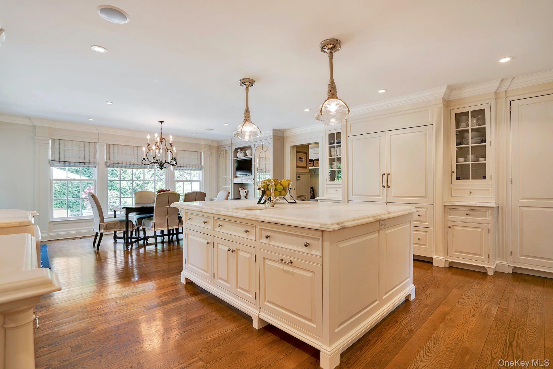 191 Elderfields Road Manhasset, NY 11030 - Photo 12 of 34 a kitchen with stainless steel appliances granite countertop a stove oven and a dining table with wooden floor