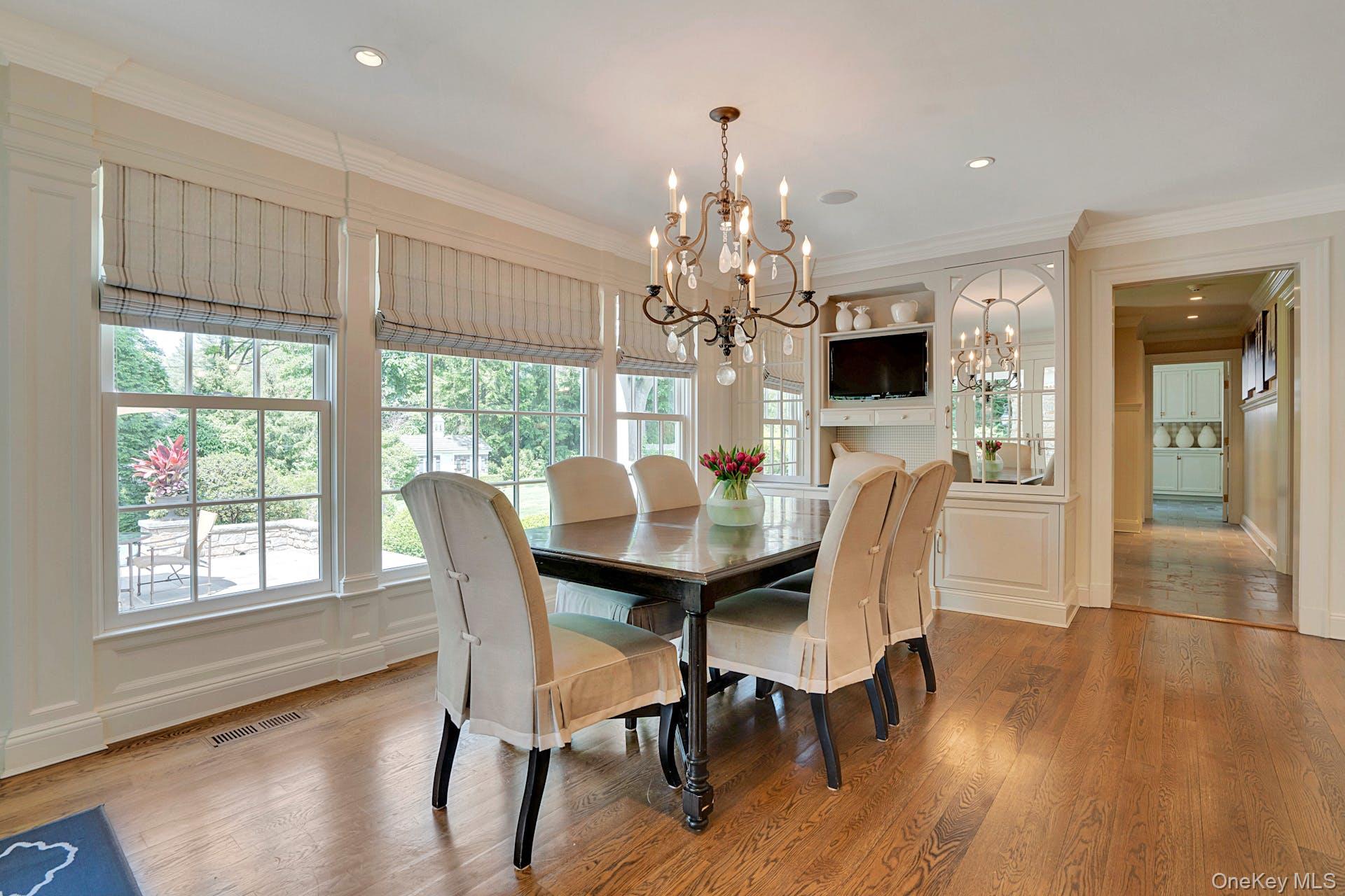 191 Elderfields Road Manhasset, NY 11030 - Photo 13 of 34 a view of a dining room with furniture a chandelier and wooden floor