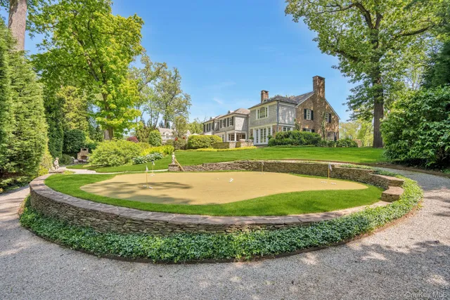 an aerial view of a house with a yard and outdoor seating