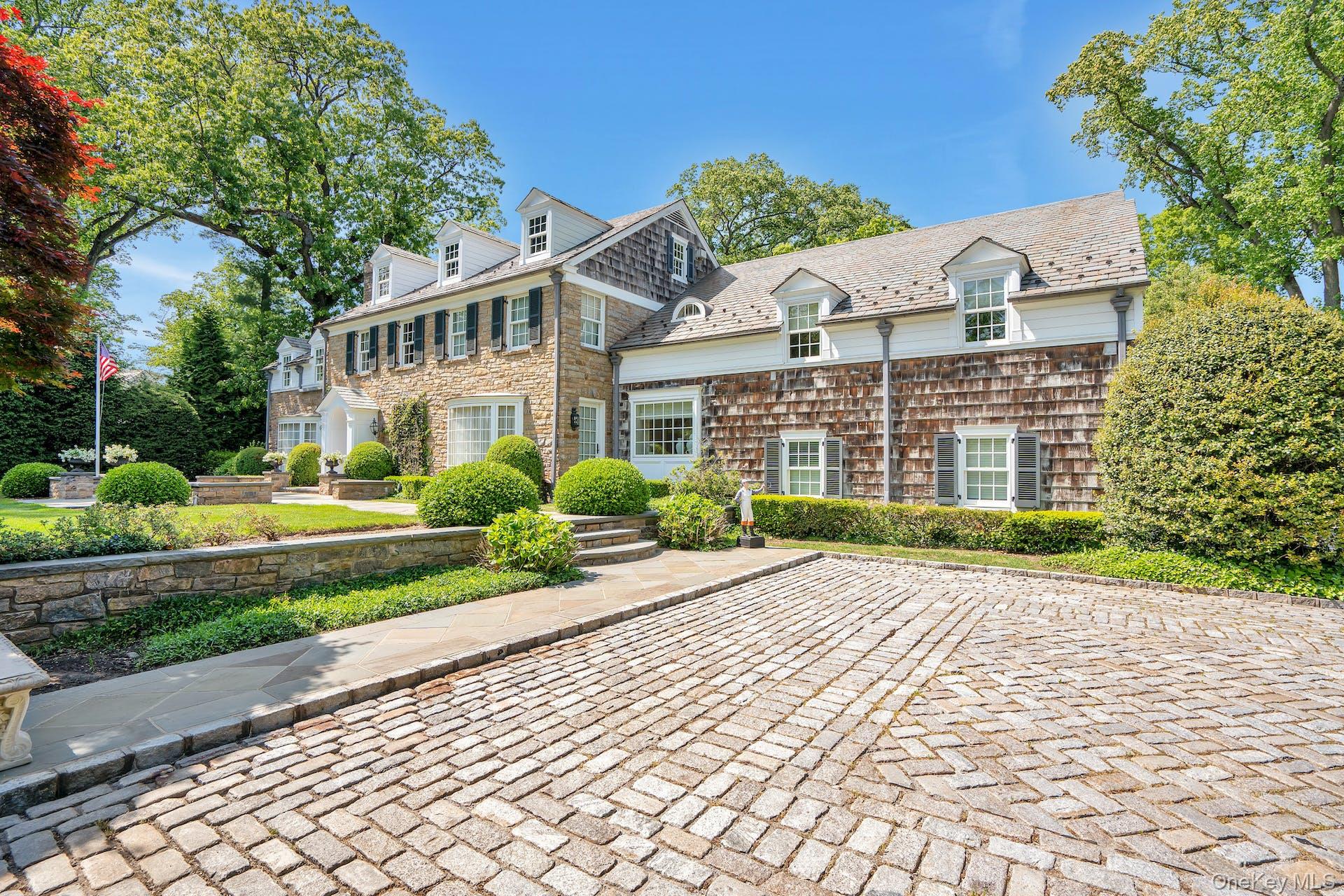 191 Elderfields Road Manhasset, NY 11030 - Photo 3 of 34 a view of a white house with a large windows plants and large trees