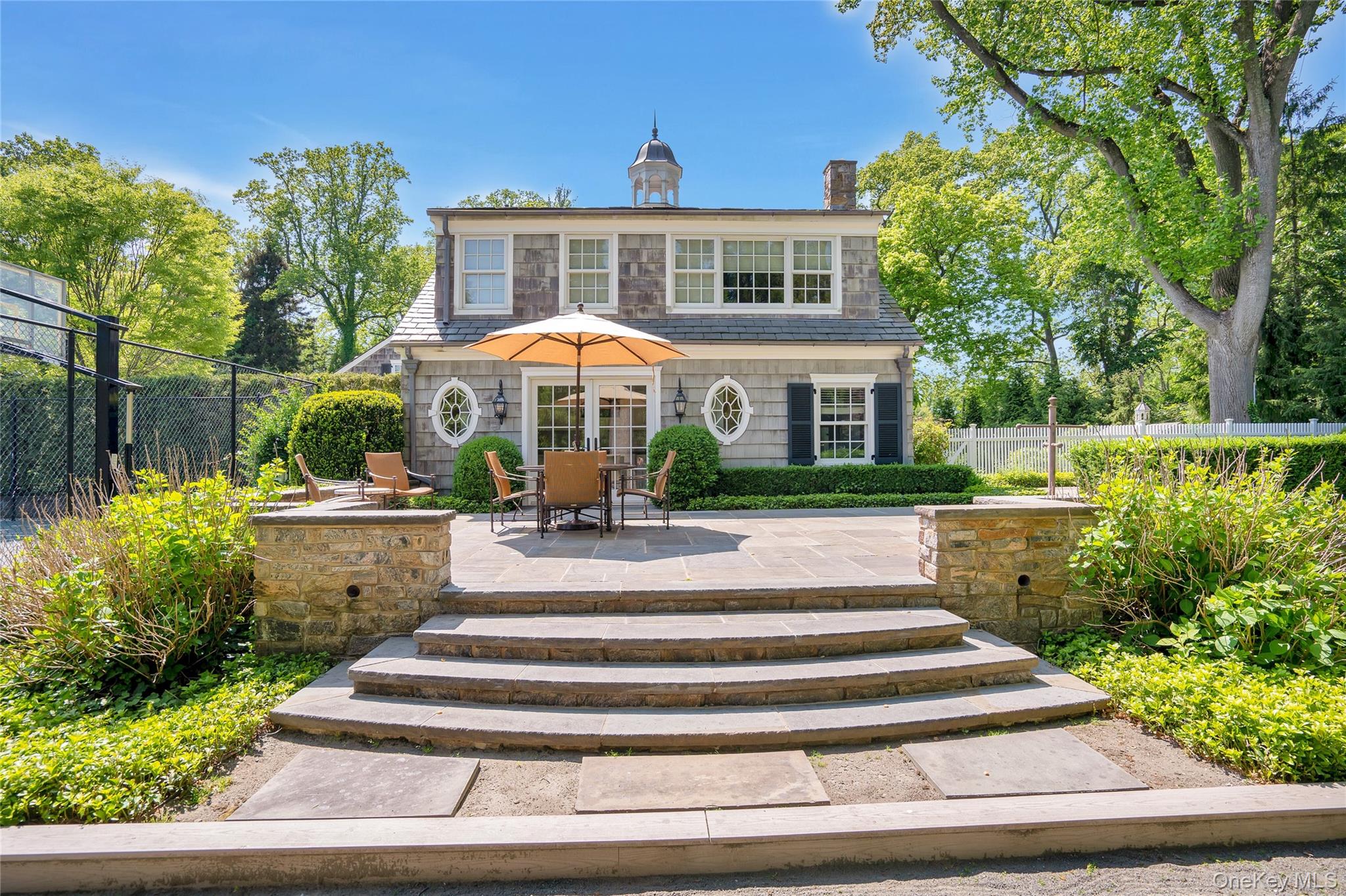 191 Elderfields Road Manhasset, NY 11030 - Photo 4 of 6 a front view of a house with yard and green space
