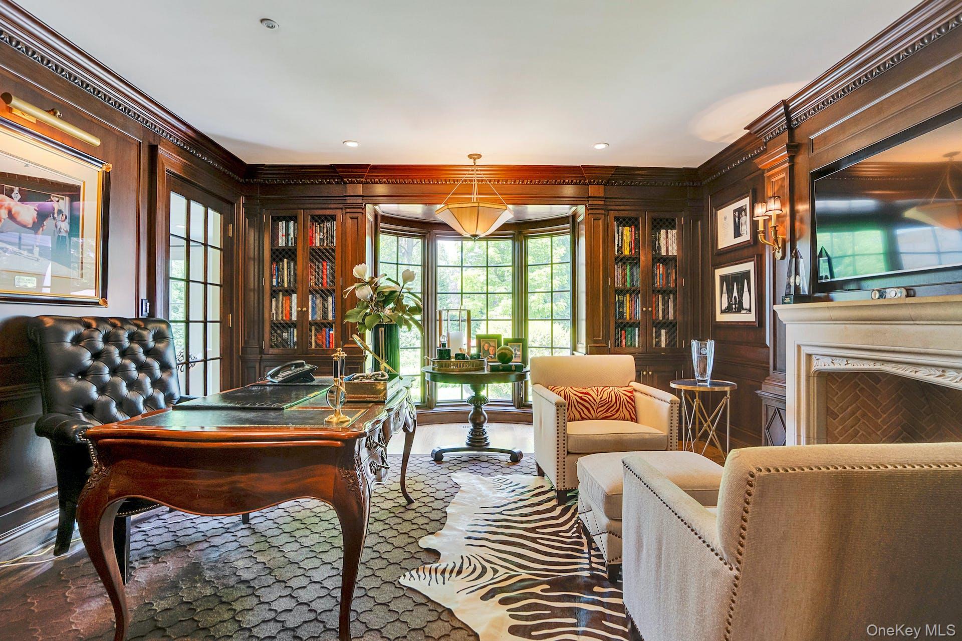 191 Elderfields Road Manhasset, NY 11030 - Photo 9 of 34 a living room with furniture a fireplace and a floor to ceiling window