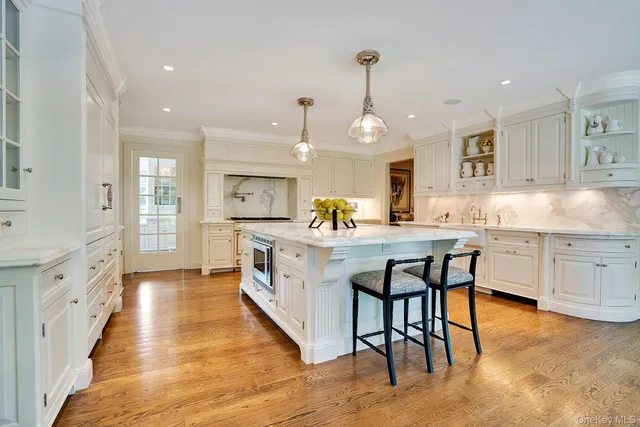 a view of a dining room with furniture a chandelier and wooden floor