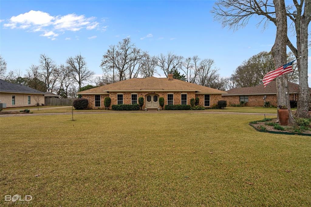 5418 Coach Road Bossier City, LA 71111 - Photo 1 of 1 a view of swimming pool with outdoor seating and covered with trees in the background