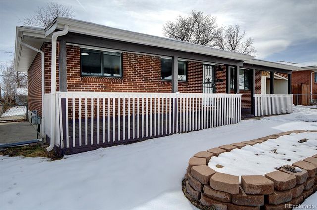 a view of a house with a wooden fence