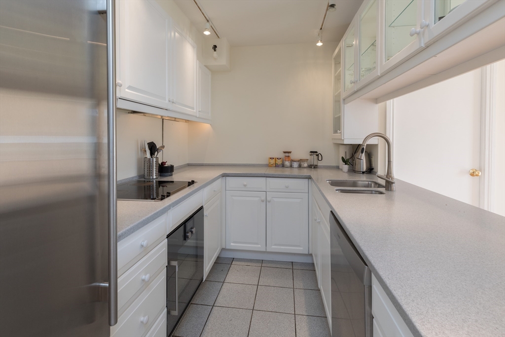 145 Pinckney Street, Unit 719 Boston, MA 02114 - Photo 4 of 11 a kitchen with a sink cabinets and appliances