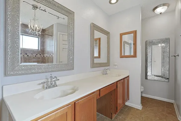a bathroom with a sink double vanity granite and a mirror