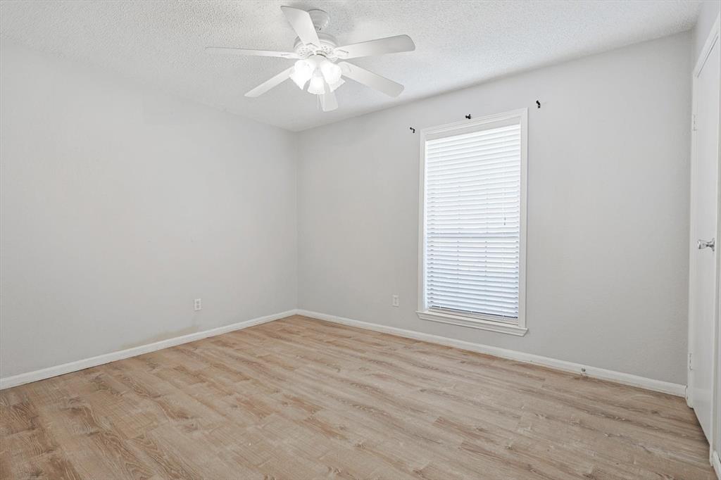 266 Pinyon Lane Coppell, TX 75019 - Photo 14 of 20 an empty room with a window and a fan