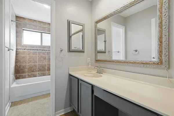 a bathroom with a sink a vanity and a bathtub
