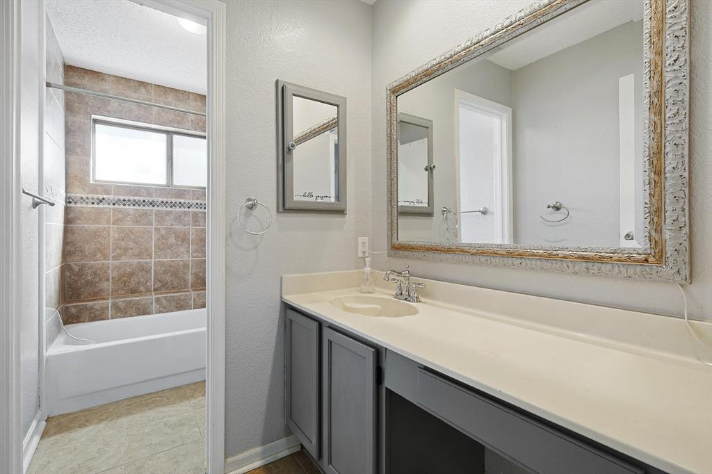 266 Pinyon Lane Coppell, TX 75019 - Photo 15 of 20 a bathroom with a sink a vanity and a bathtub