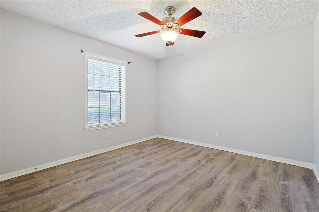 266 Pinyon Lane Coppell, TX 75019 - Photo 16 of 20 an empty room with wooden floor and windows