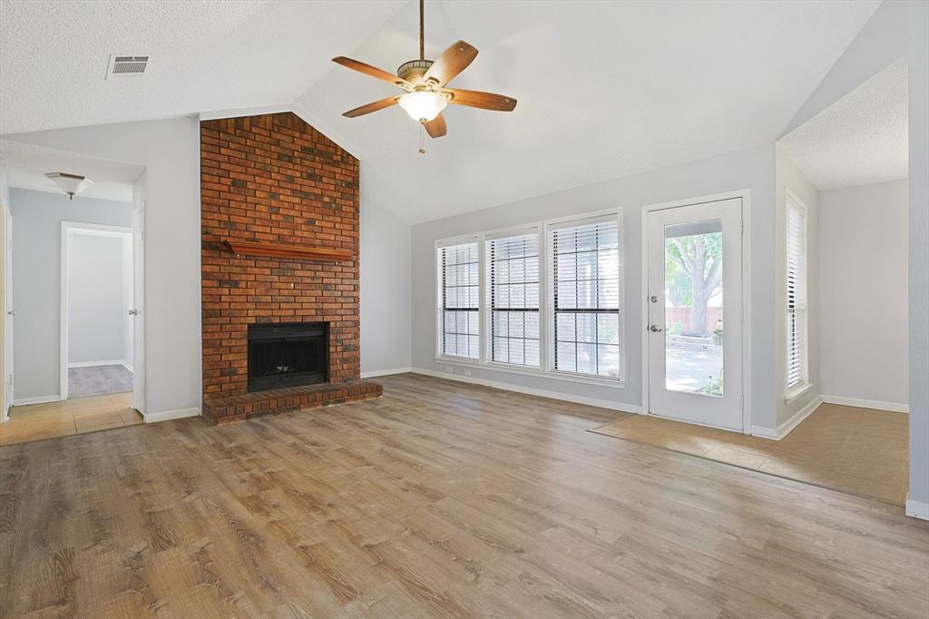 266 Pinyon Lane Coppell, TX 75019 - Photo 3 of 20 a view of an empty room with a fireplace and a window