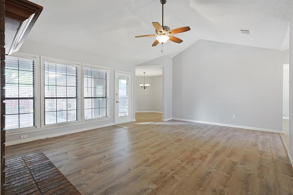 266 Pinyon Lane Coppell, TX 75019 - Photo 5 of 20 an empty room with wooden floor fan and windows