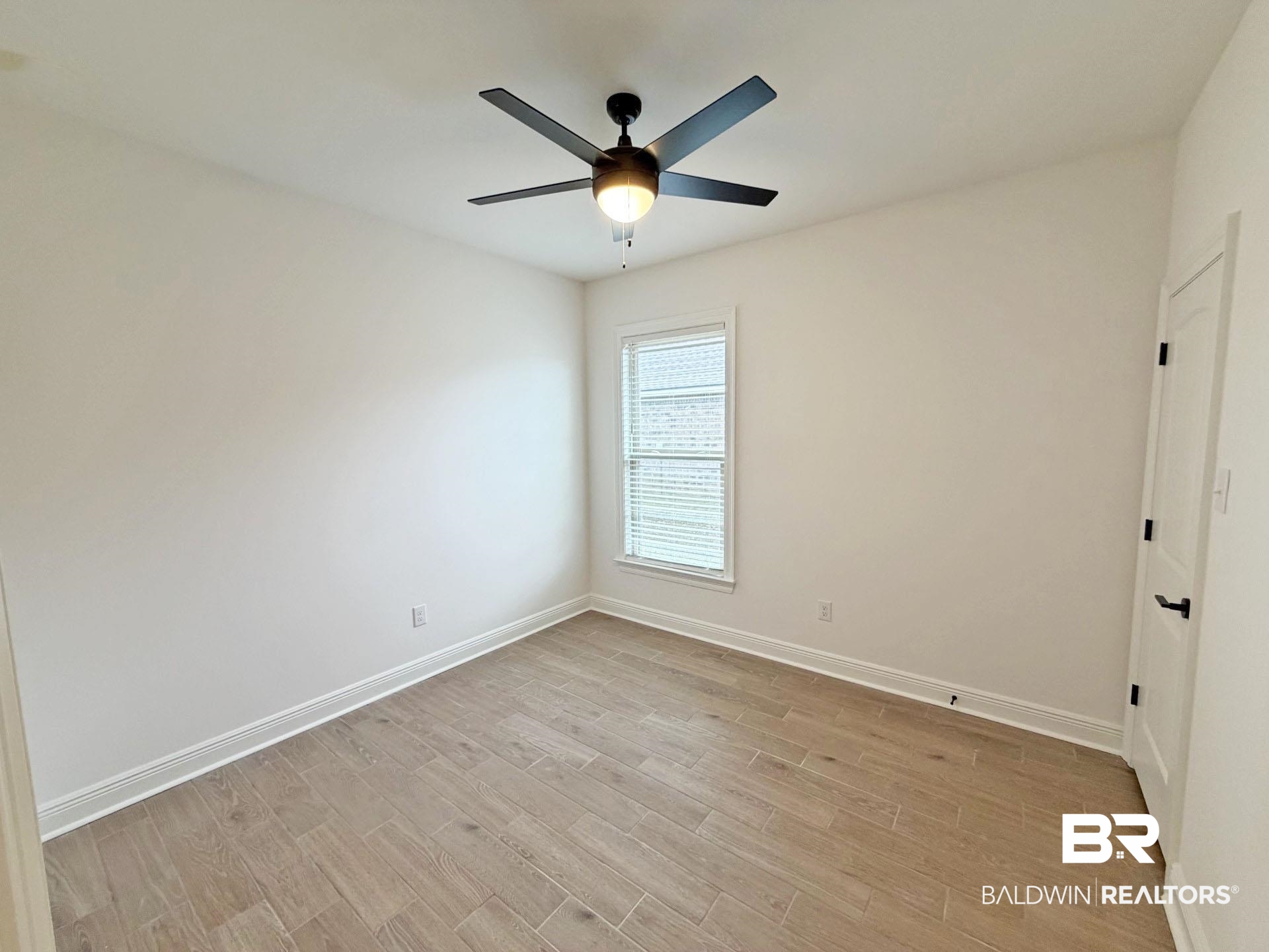 1753 Breckinridge Place Foley, AL 36535 - Photo 16 of 24 Bright room featuring wood-finish flooring, a contemporary ceiling fan with integrated lighting, white baseboards, and a window with blinds