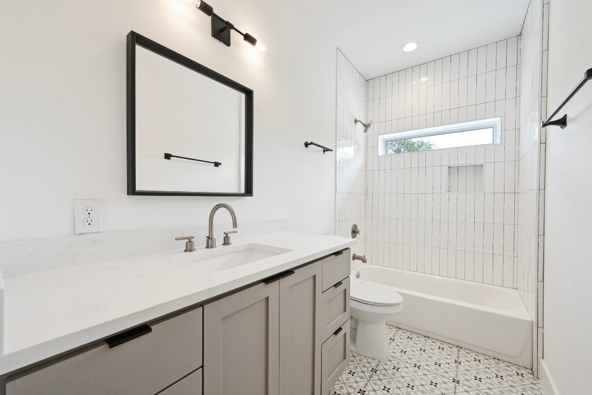504 Normandy Street, Unit A Austin, TX 78745 - Photo 13 of 20 a bathroom with a sink a toilet and shower