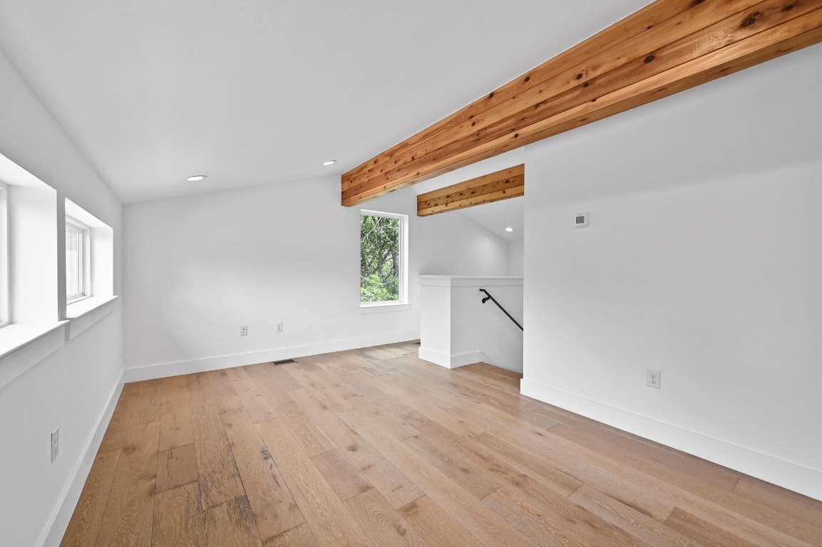 504 Normandy Street, Unit A Austin, TX 78745 - Photo 16 of 20 a view of an empty room with wooden floor and a window