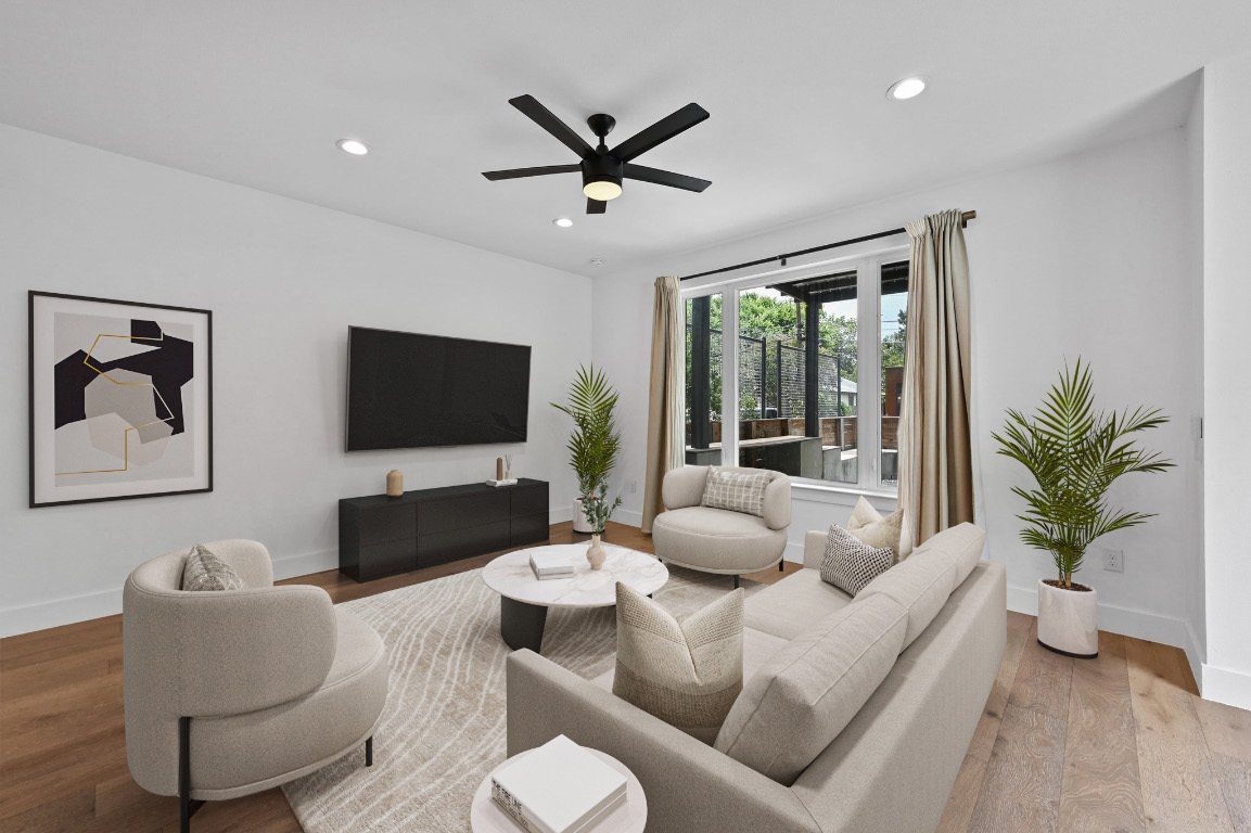 504 Normandy Street, Unit A Austin, TX 78745 - Photo 7 of 20 a living room with furniture a ceiling fan and a large window