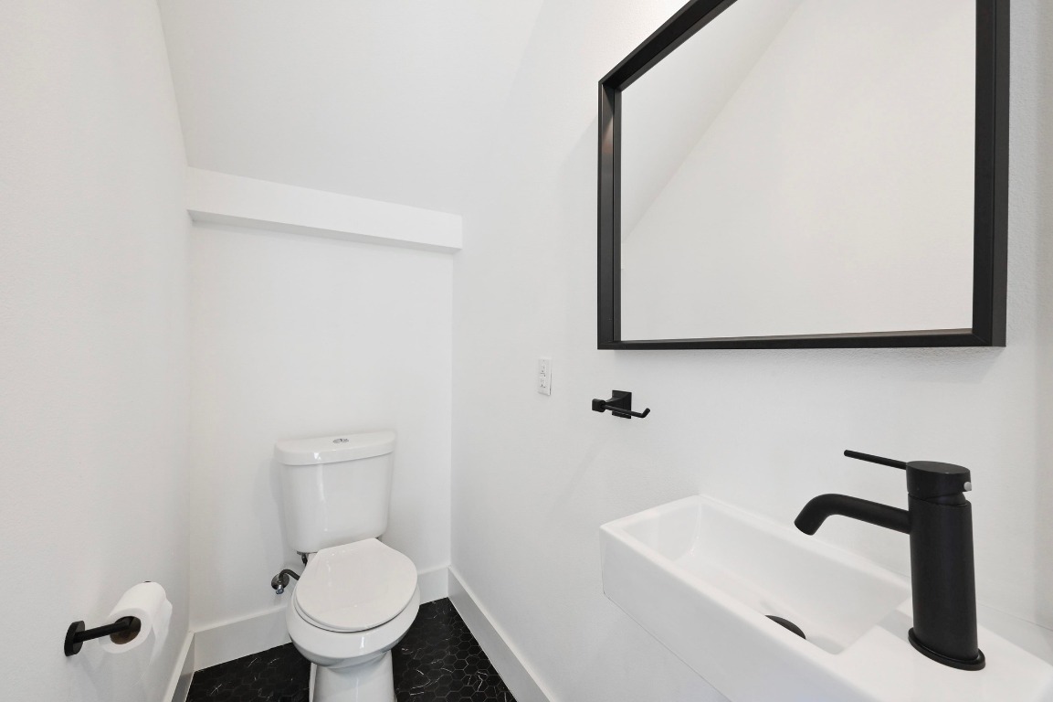 504 Normandy Street, Unit A Austin, TX 78745 - Photo 8 of 20 a bathroom with a sink and a toilet